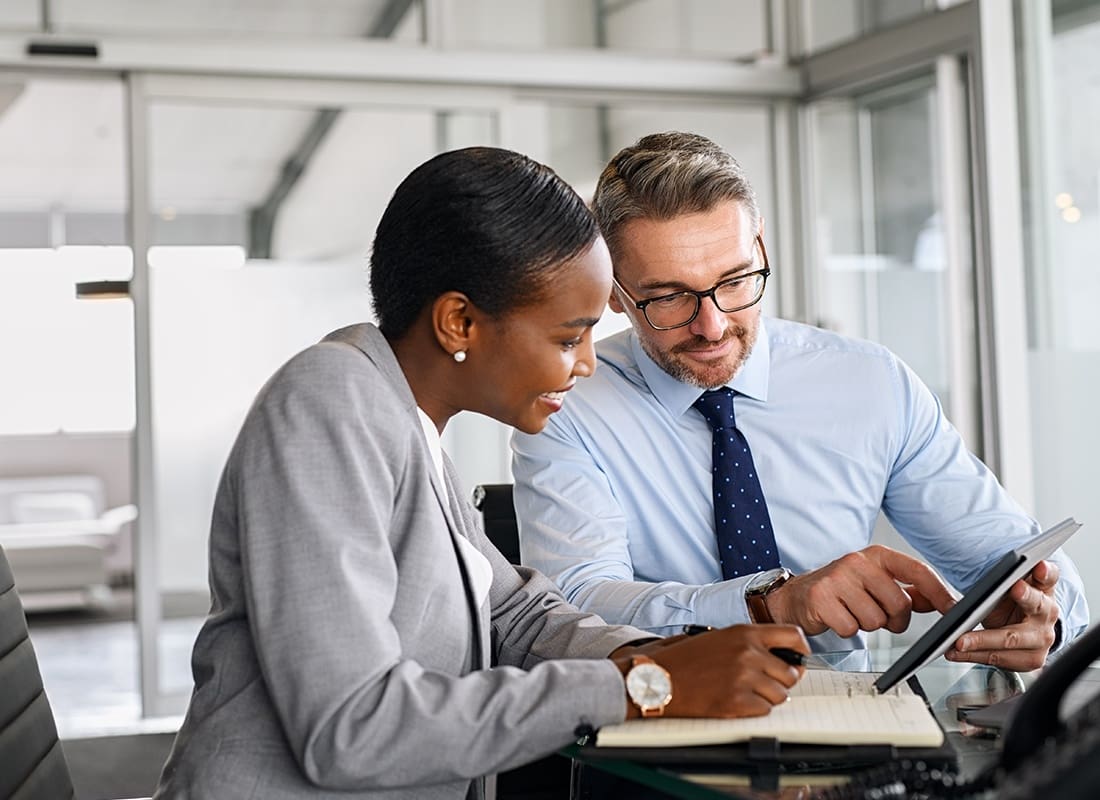 Business Insurance - Two Business Professionals Looking at a Laptop