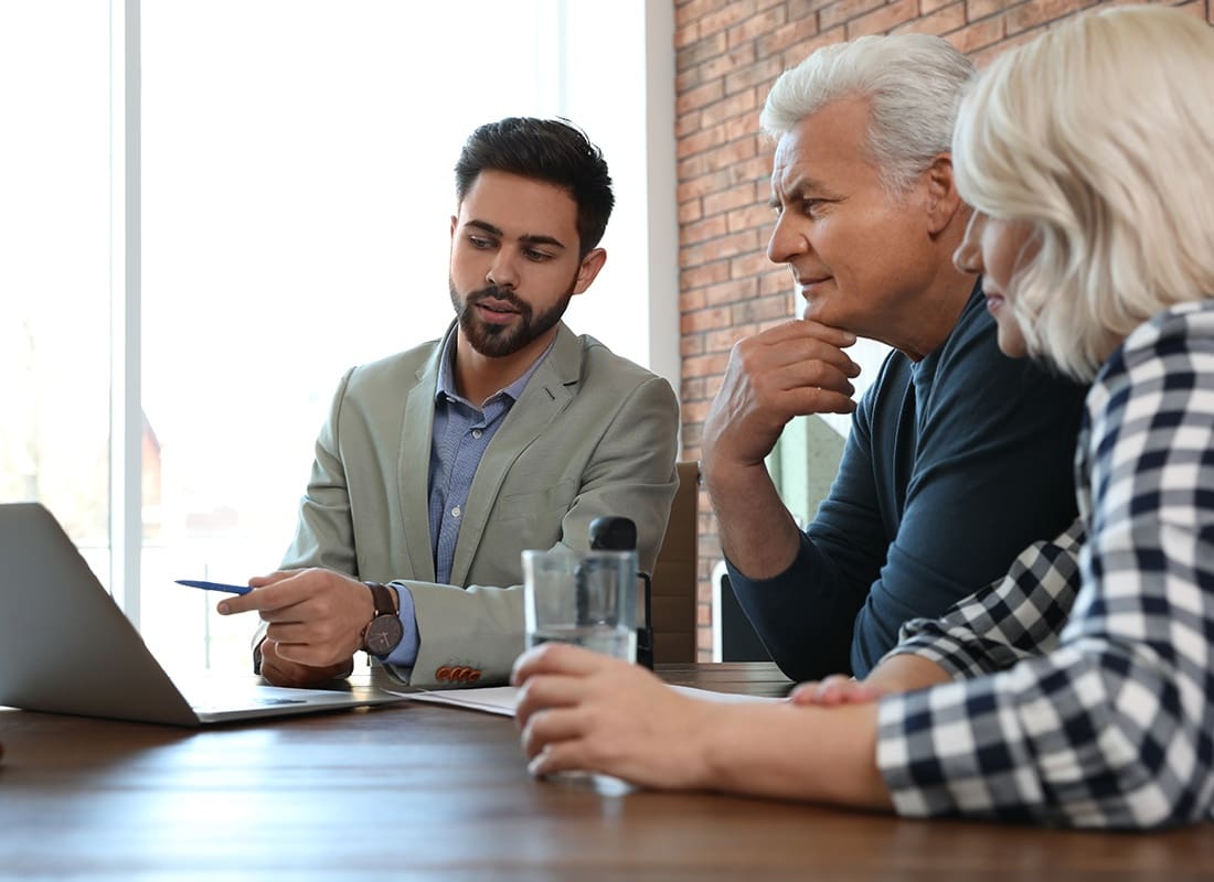 Insurance Solutions - Agent and a Couple in an Office